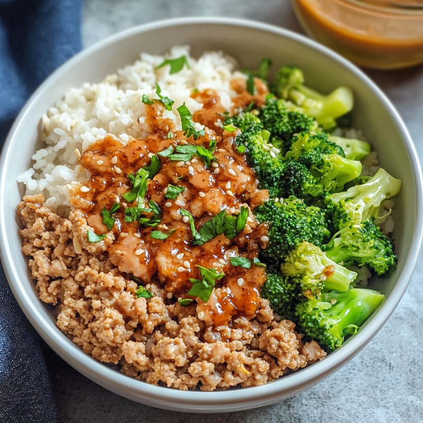A plate topped with rice, broccoli, and a fiery sauce.