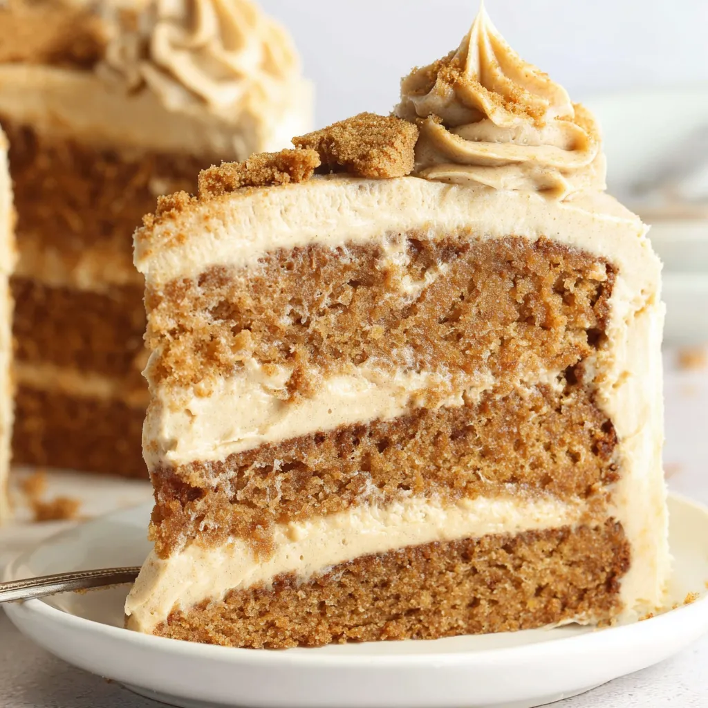 A slice of Biscoff cake on a plate.