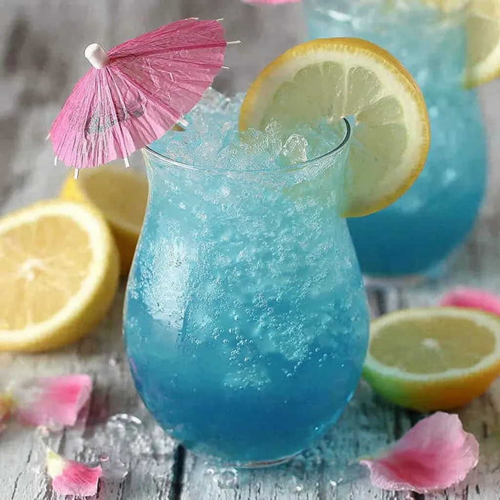 A tropical blue cocktail with a pink umbrella.