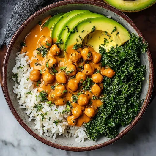 A bowl of food with rice, chickpeas, avocado, and broccoli.