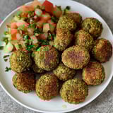 A platter stacked with crispy golden air-fried falafel.