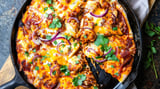 A slice of BBQ chicken pizza straight from the oven.