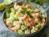 Shrimp salad topped with a sprinkle of herbs in a big bowl.